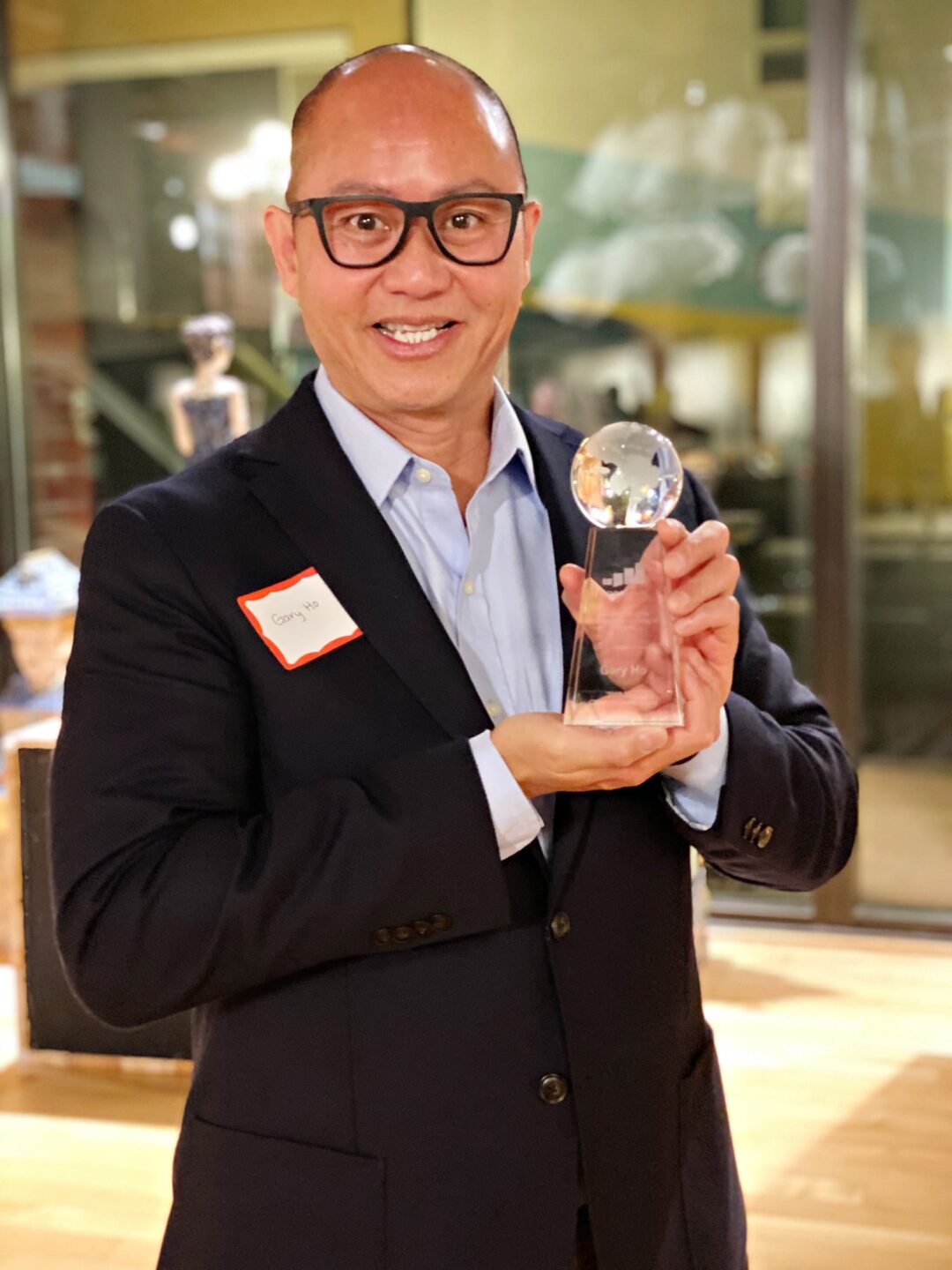 Gary Ho, gout advocate smiling with his award for advocacy