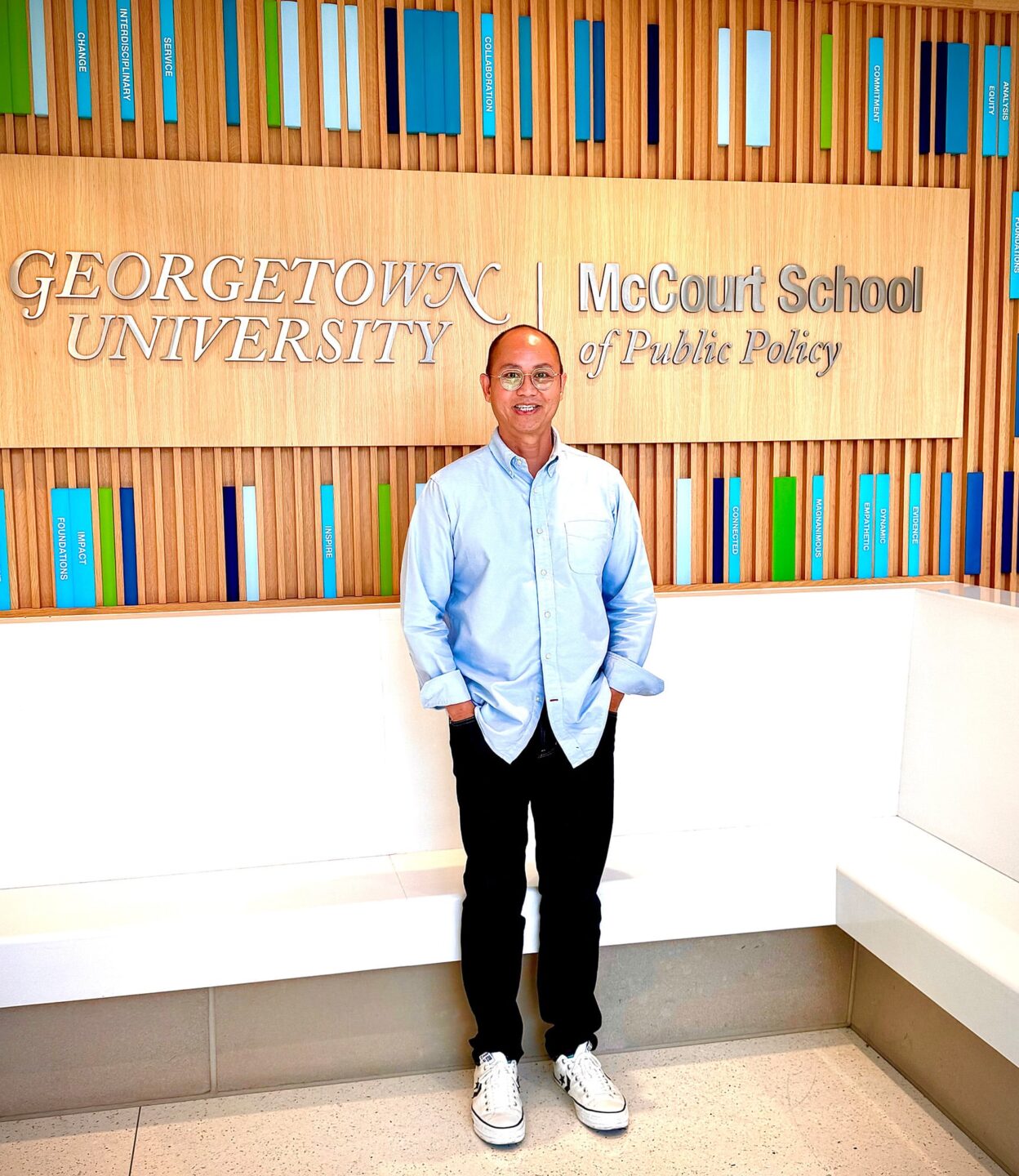 Gary Ho posing in front of a Georgetown University sign