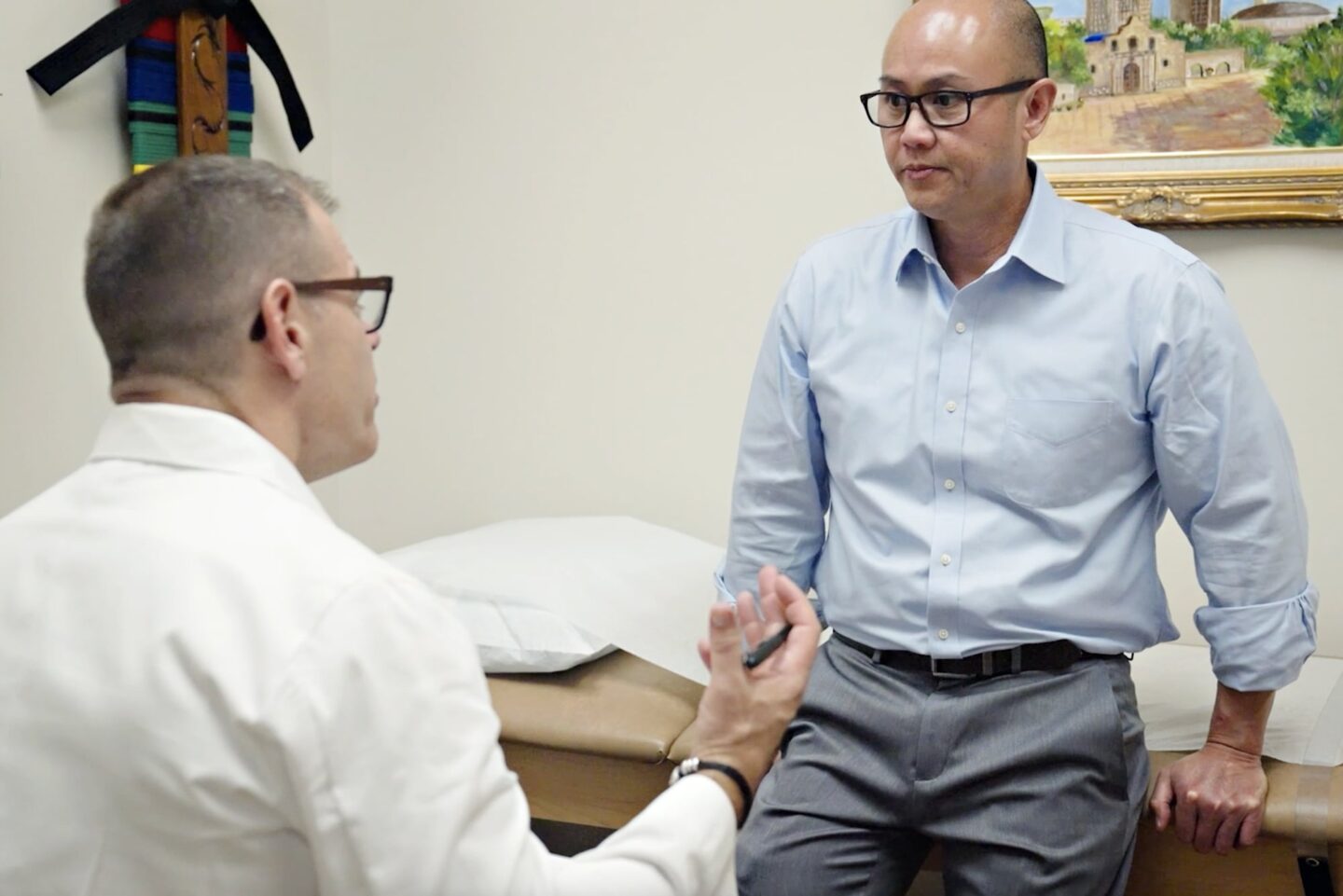 A gout doctor and his patient talking in an exam room