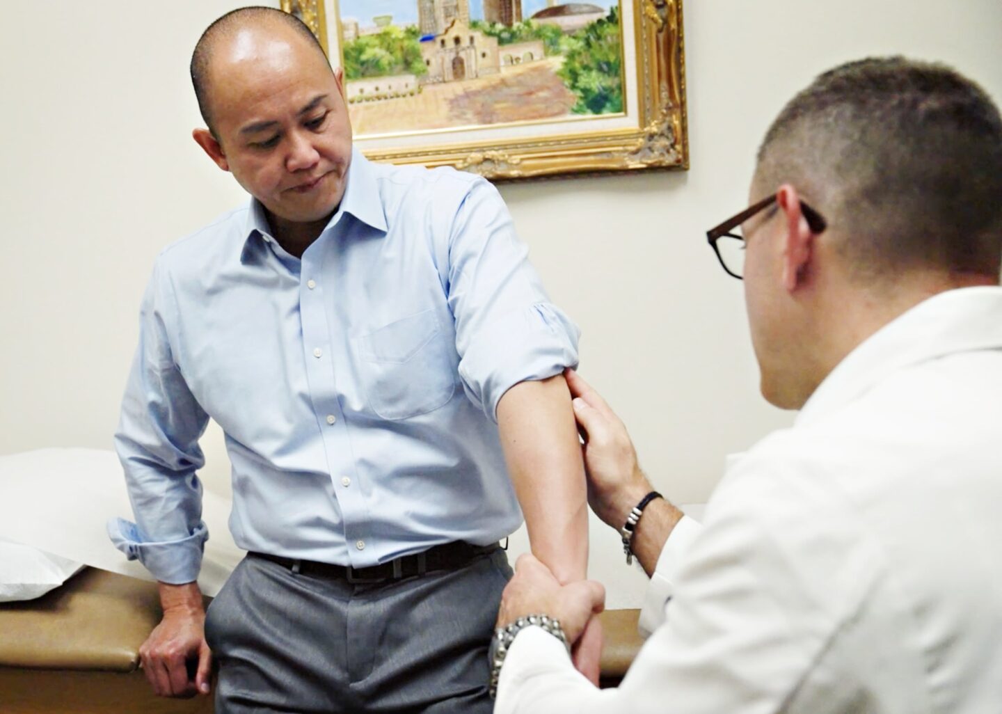 a gout doctor giving his patient a joint exam