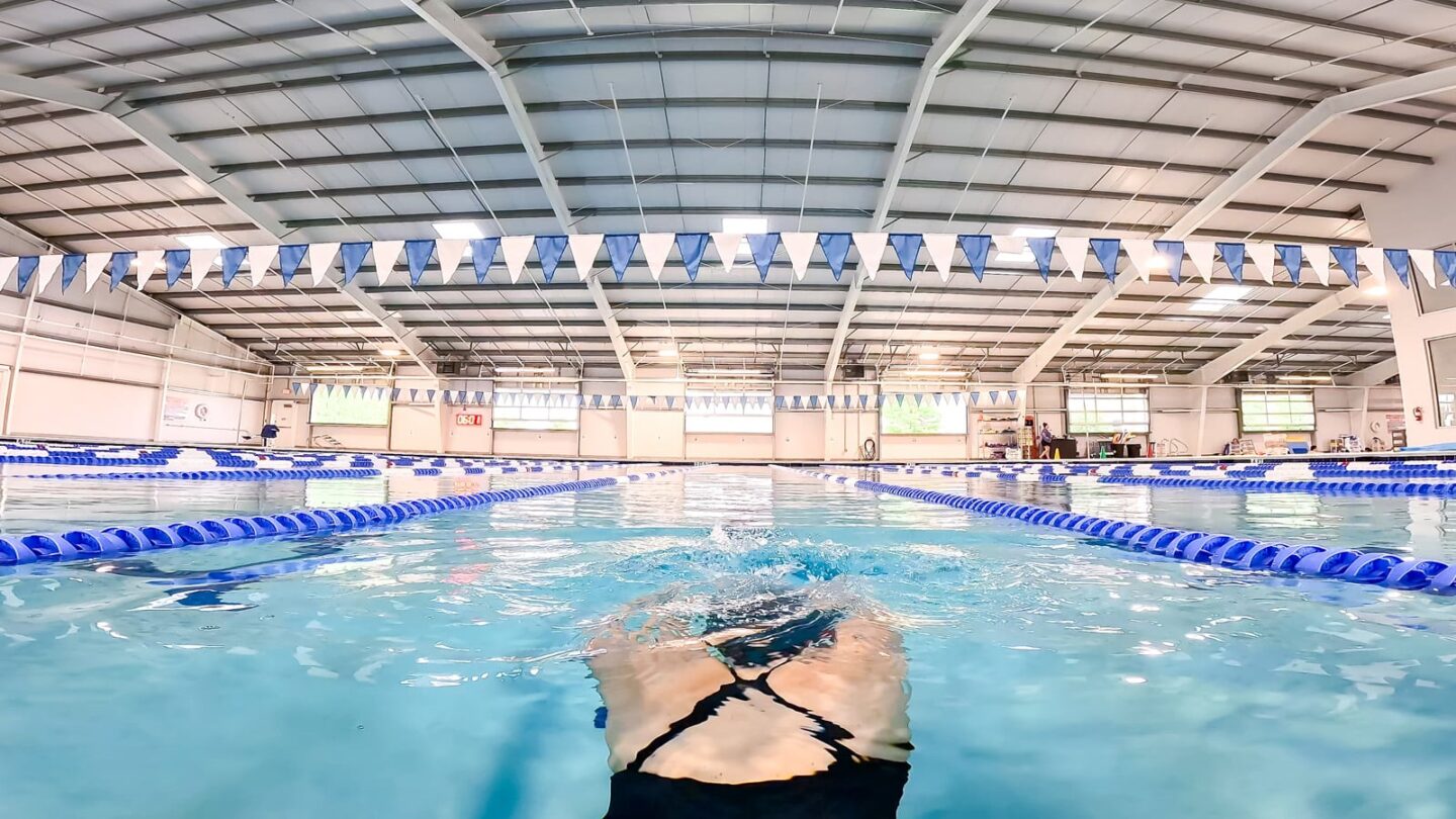 Swimmer underwater pushing off the wall, celebrating Gout Awareness Day 2026, flare free