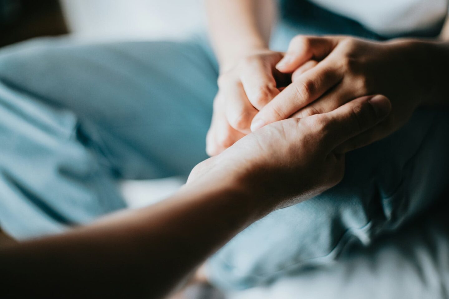 close up of hands holding in a supportive way for gout support